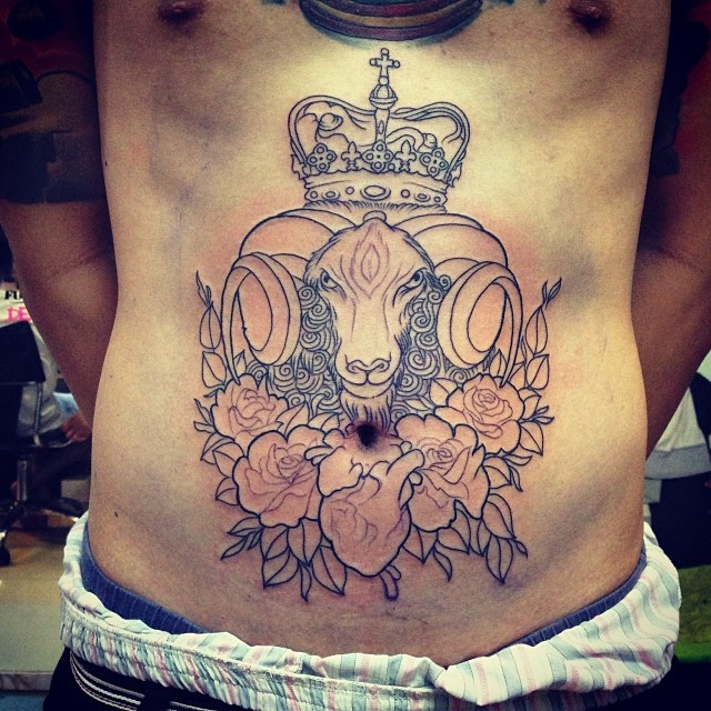 Goat and flowers stomach tattoo