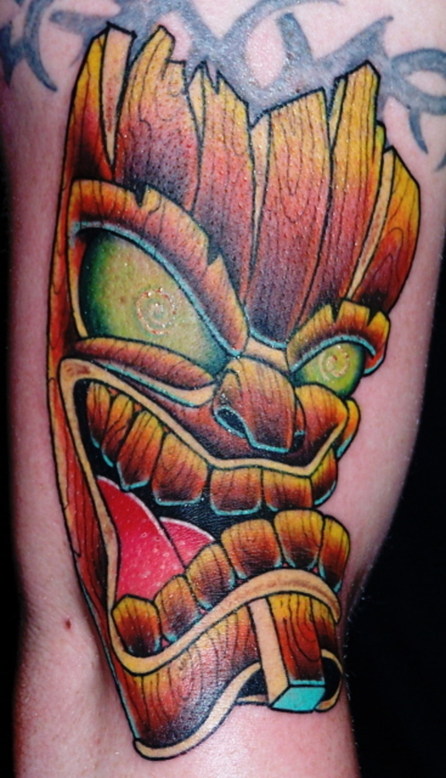 Green eyes tiki tattoo