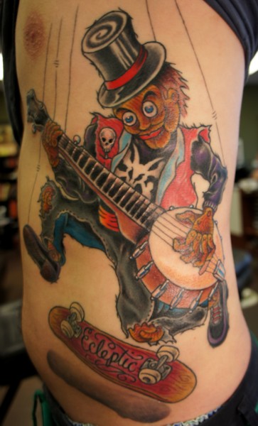 Guitar playing puppet tattoo