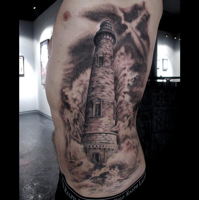 Huge lighthouse side tattoo