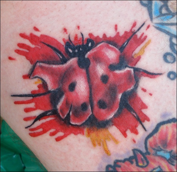 Bloody ladybug arm tattoo