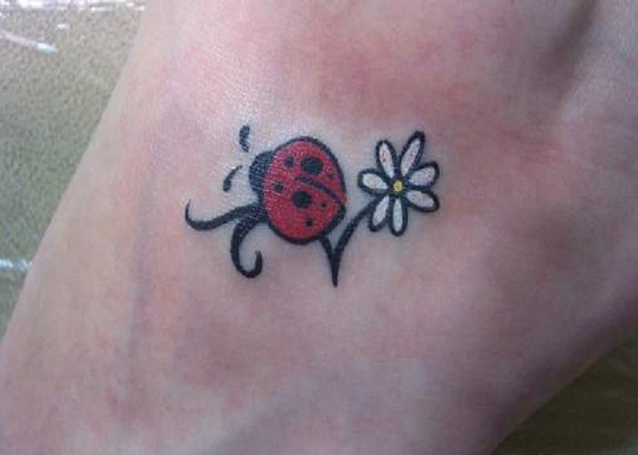 Ladybug and flower tattoo