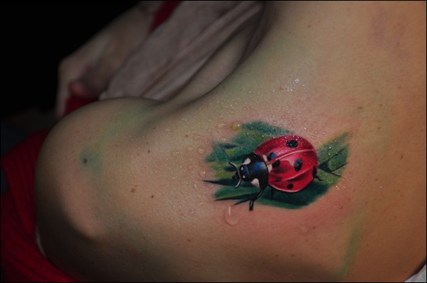 Ladybug on a leaf shoulder tattoo