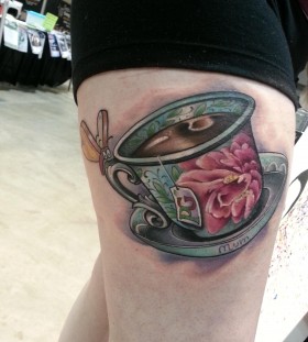 Large teacup leg tattoo