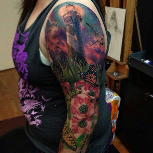 Lighthouse and flowers full arm tattoo