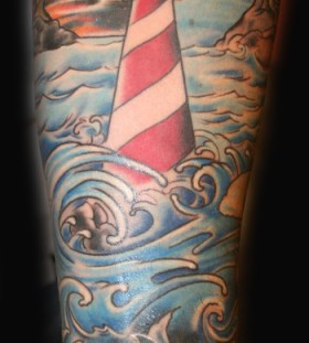 Lighthouse and waves tattoo