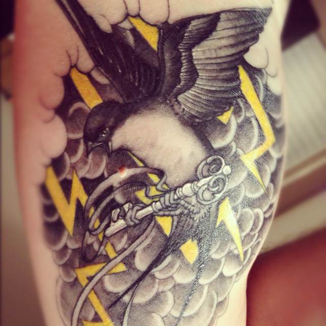 Lightning and bird tattoo