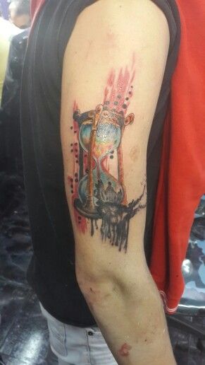 Lovely arm’s sand clock tattoo