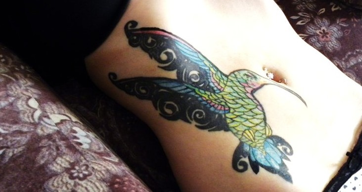 Lovely hummingbird stomach tattoo