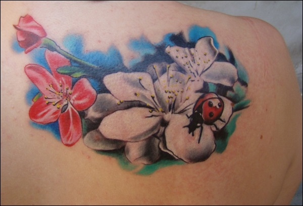 Lovely ladybug and flowers tattoo