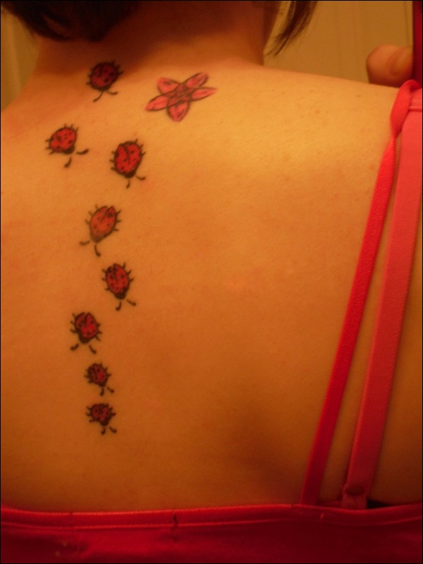 Many ladybugs back tattoo