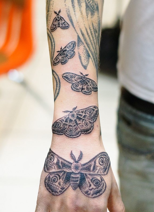 Many moths arm tattoo