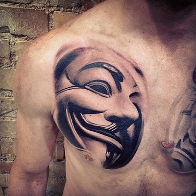 Mask of V chest tattoo