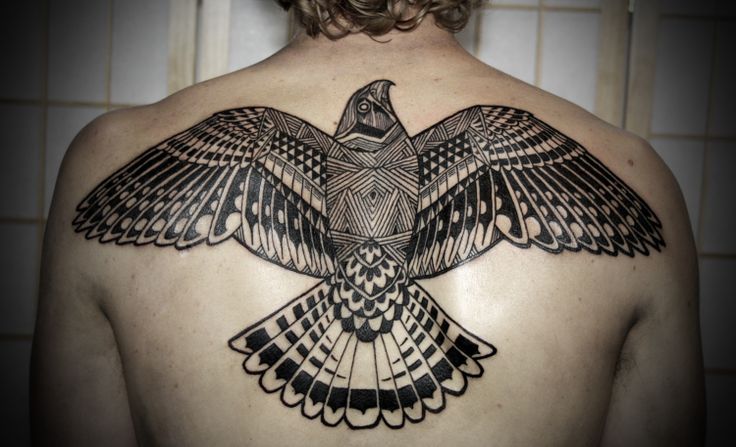 Men’s back tribal bird tattoo