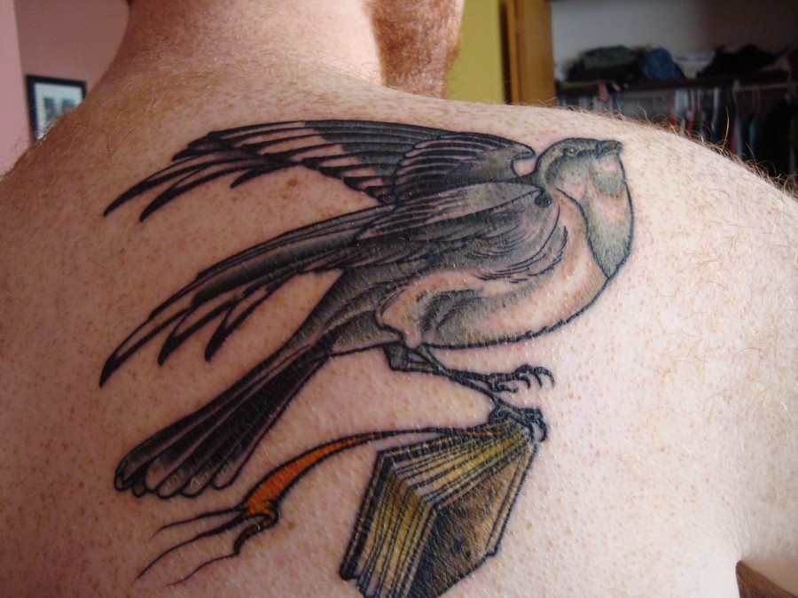 Mockingbird with a book tattoo