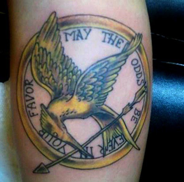 Mockingjay logo and quote tattoo