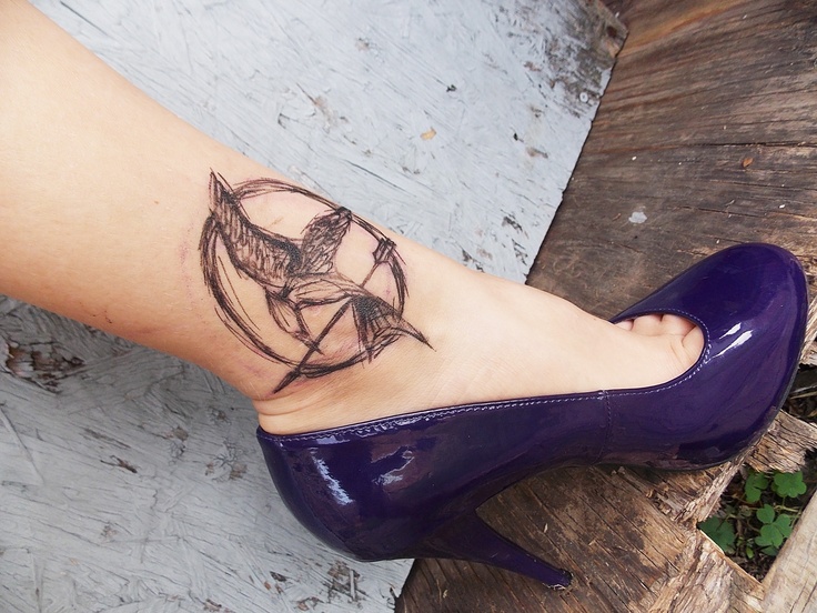 Mockingjay logo ankle tattoo