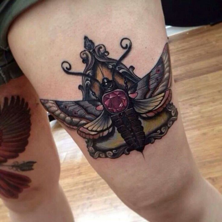 Moth with jewel tattoo