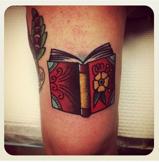 Nice book tattoo by Charley Gerardin