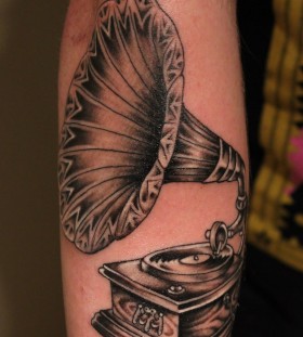 Old gramophone arm tattoo