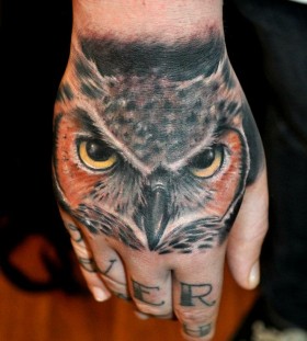 Owl hand tattoo by Benjamin Laukis