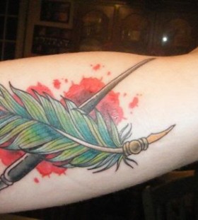 Paint brush and feather tattoo