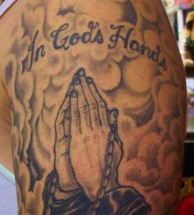 Praying hands and clouds tattoo