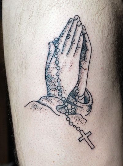 Praying hands and cross tattoo