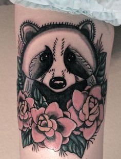 Raccoon and flowers tattoo