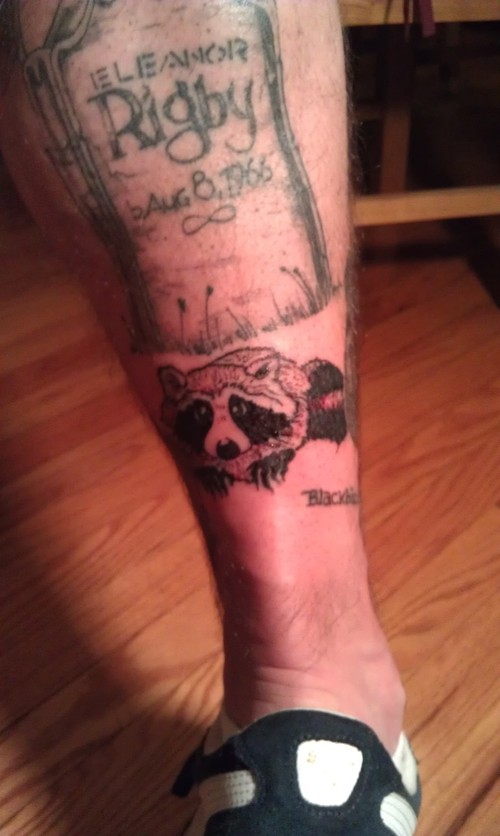 Raccoon and gravestone tattoo