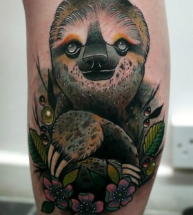 Realistic sloth and flowers tattoo
