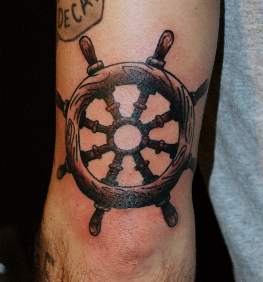 Realistic wooden wheel tattoo