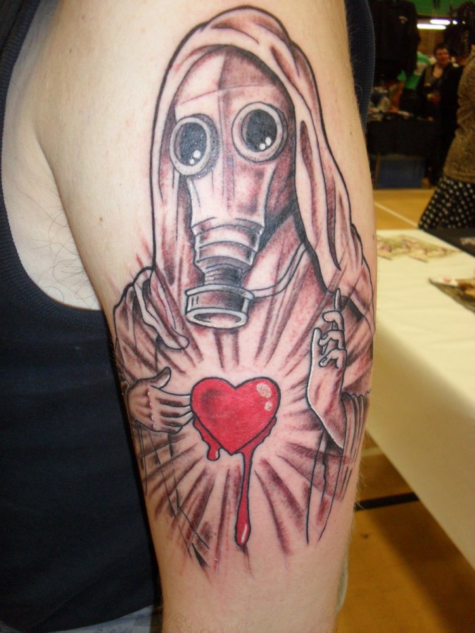 Religious gas mask and heart tattoo