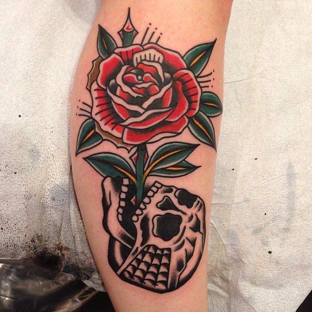 Rose growing from skull tattoo by Nick Oaks