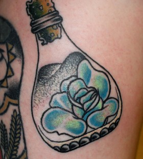 Rose in a bottle tattoo