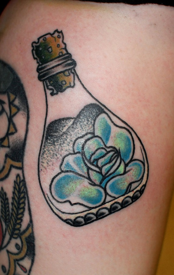 Rose in a bottle tattoo