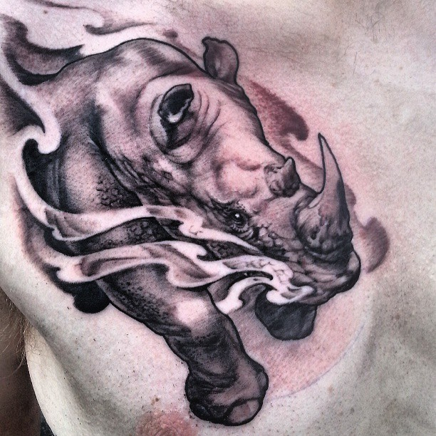 Running rhino chest tattoo