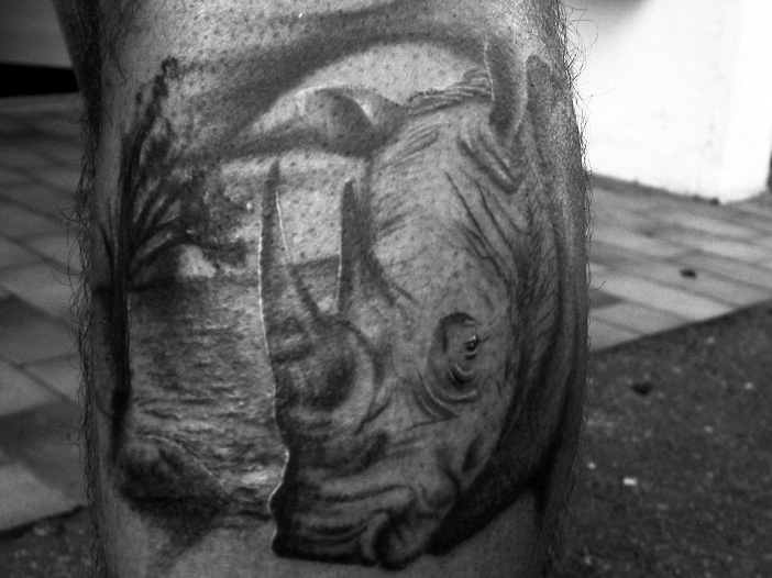 Sad rhino leg tattoo