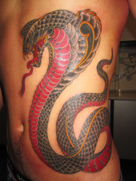 Scary cobra side tattoo