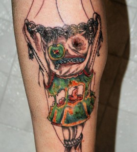 Scary puppet leg tattoo