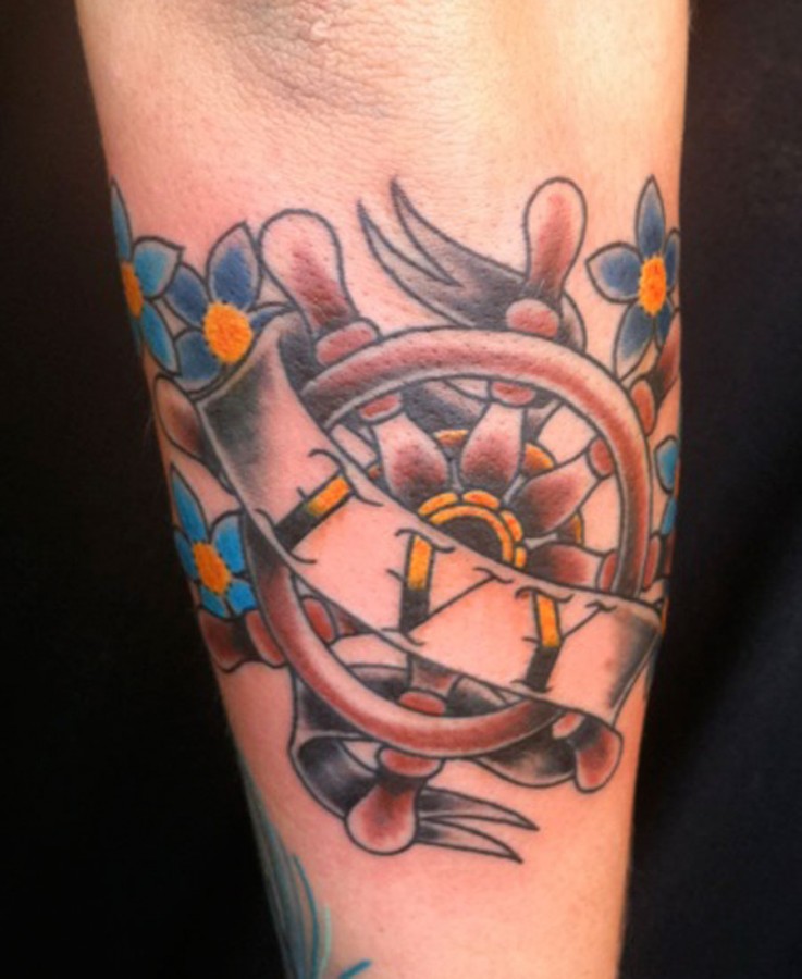 Ship’s wheel arm tattoo