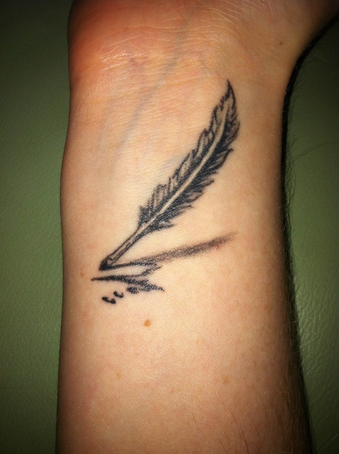 Simple feather pen arm tattoo