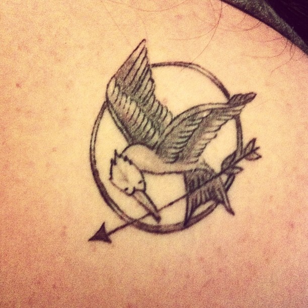 Simple mockingjay logo tattoo