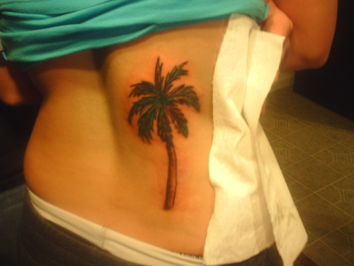 Simple palm tree back tattoo