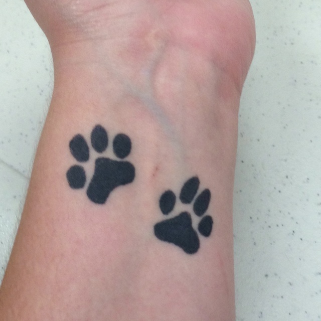 Simple paw arm tattoo