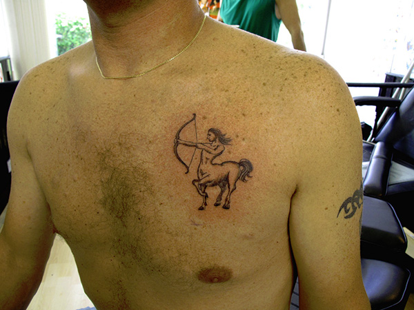 Simple sagittarius chest tattoo