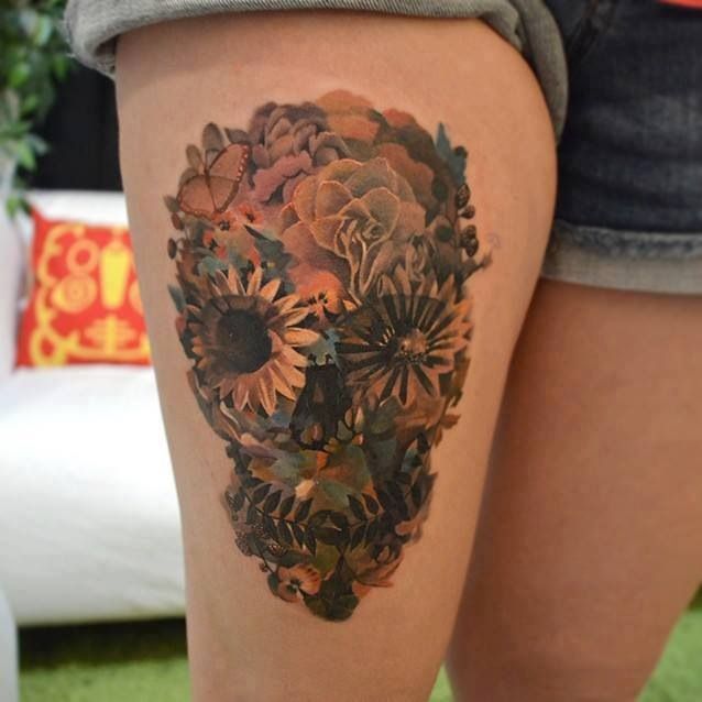 Skull of flowers leg tattoo