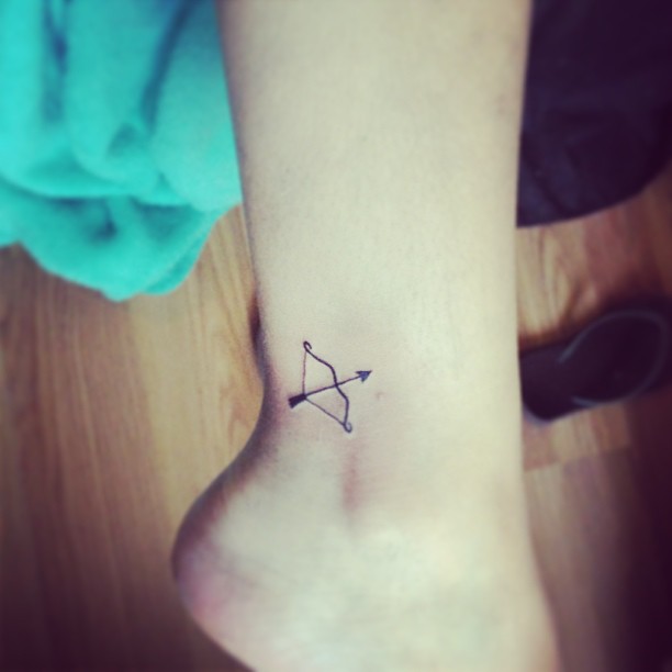 Small bow and arrow tattoo