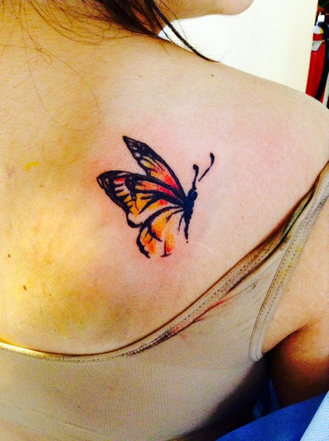 Small red watercolor butterfly tattoo