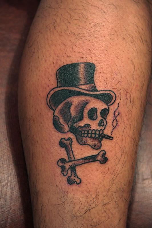 Smoking skull leg tattoo